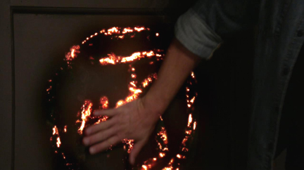 Dean cuts his own hand and activates the sigil.